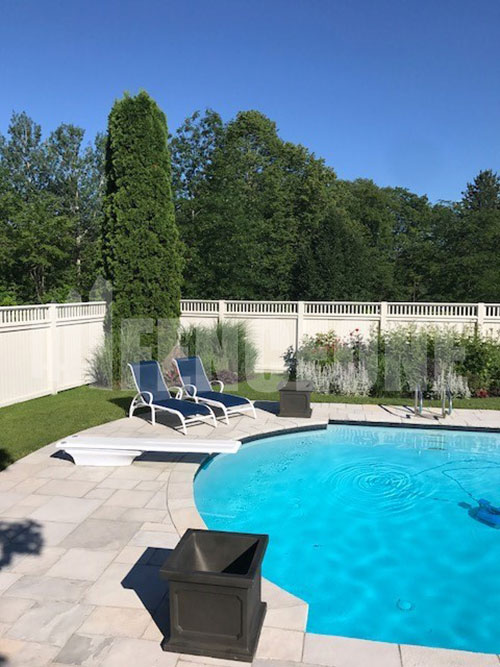 custom white vinyl fence surrounding pool