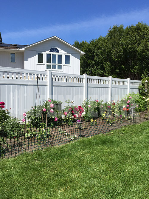 white vinyl fence surrounding garden