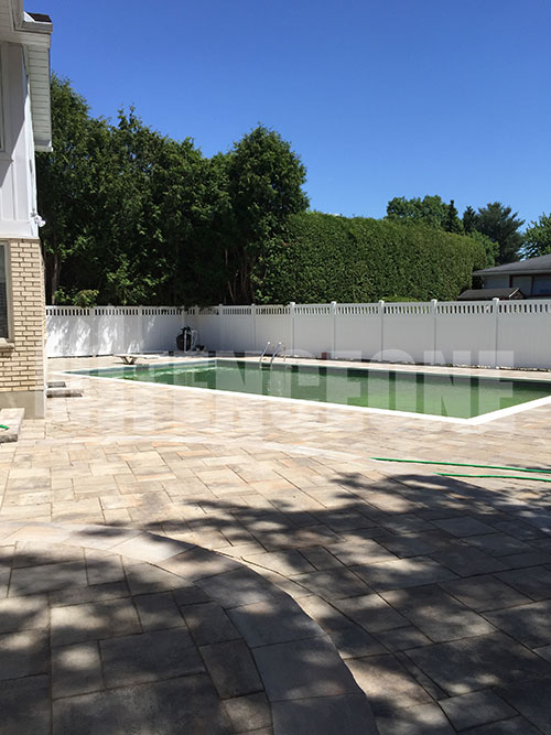 white vinyl fence surrounding pool