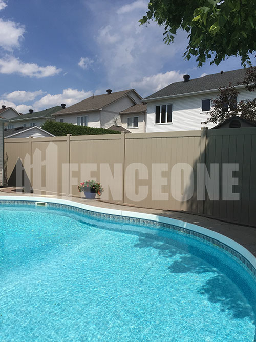tan vinyl fence surrounding pool