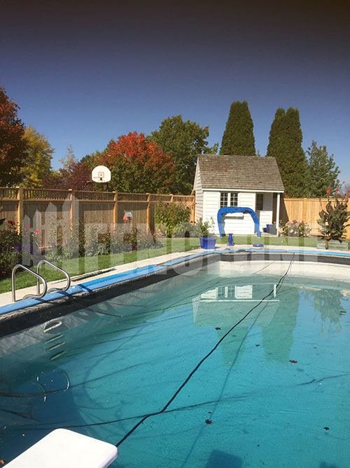 in-ground pool with fence surrounding