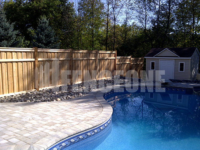 in-ground pool with a fence surrounding pool